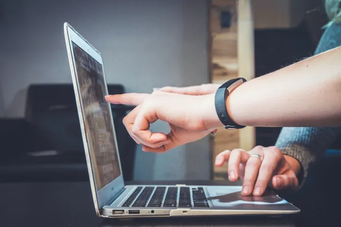 reviewing a website design on a laptop